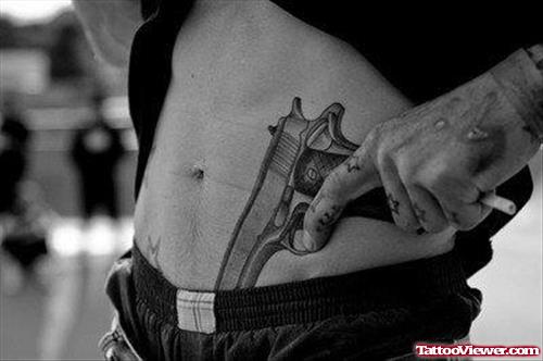 Gun Tattoo On Man Left Hip