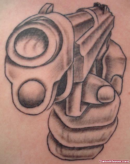 Grey Ink Gun In Hand Tattoo