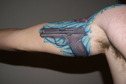 Realistic Gun Tattoo On Bicep