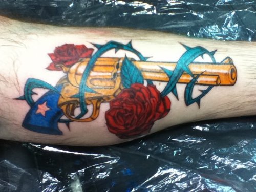 Red Rose Flowers And Colored Gun Tattoo On Leg