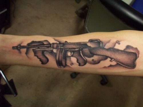 Grey Ink Gun Tattoo On Full Sleece