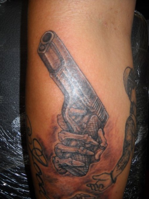 Skeleton Hand And Gun Tattoo
