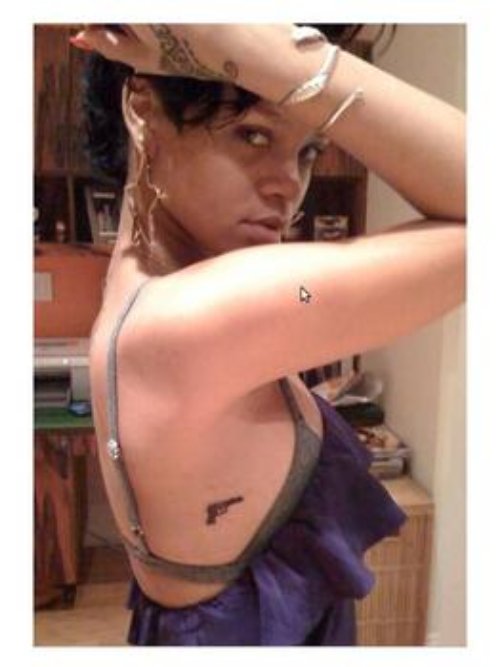 Small Gun Tattoo On Rihanna Side Rib