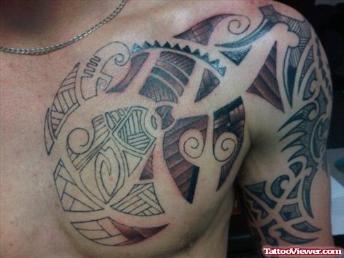 Tribal Chest And Half Sleeve Tattoo
