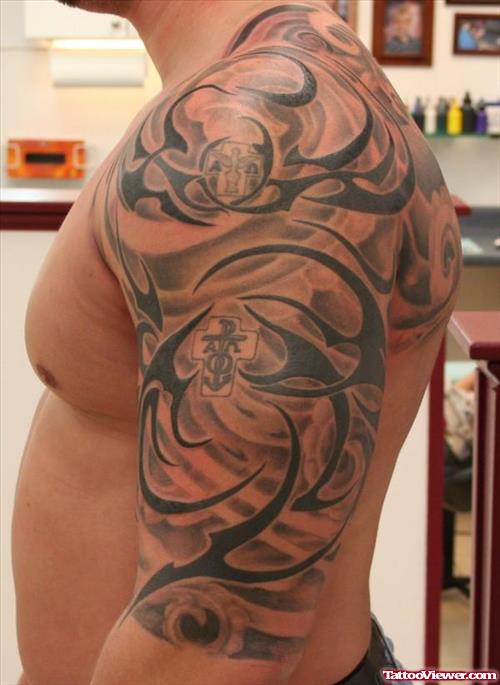Man With Tribal Half Sleeve Tattoo
