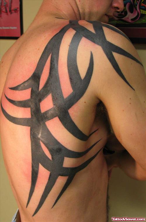 Black Tribal Half Sleeve And Side Rib Tattoo