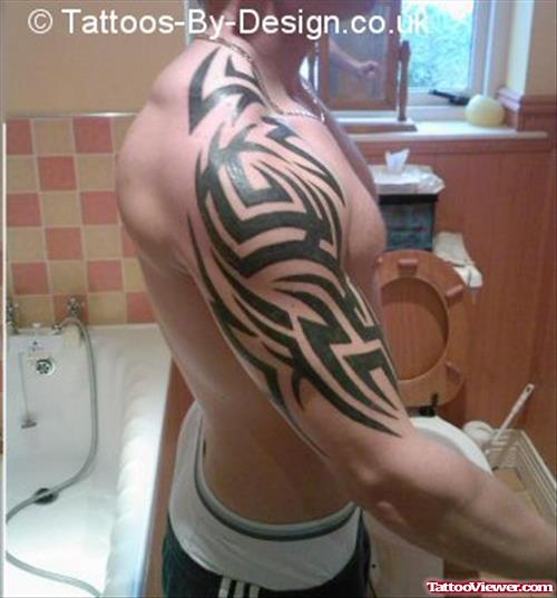 Muscular Tribal Half Sleeve Tattoo