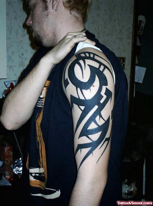 Guy With Tribal Half Sleeve Tattoo