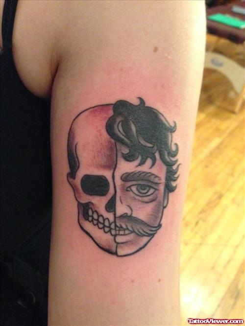Grey Ink Skull Halloween Tattoo On Bicep