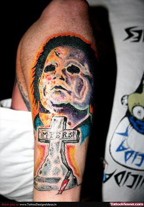 Cross And Halloween Tattoo On Left Sleeve