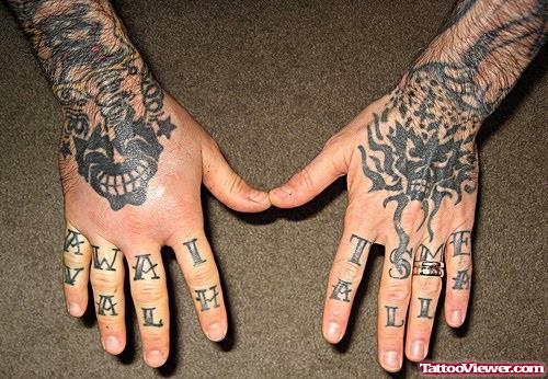 Black Skull And Tribal Hand Tattoos