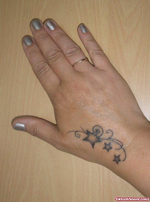 Attractive Grey Ink Stars Hand Tattoo