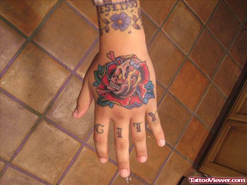 Red Rose Flower And Skull Hand Tattoo