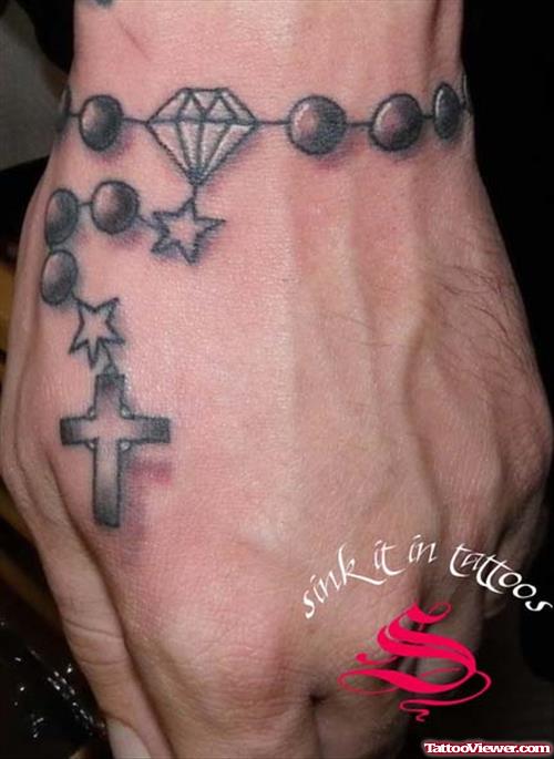 Grey Ink Cross Rosary Hand Tattoo