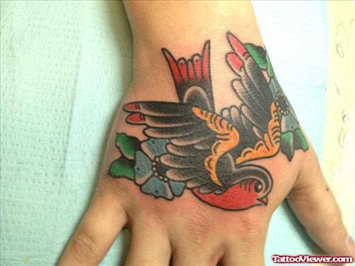 Color Flowers And Flying Bird Hand Tattoo