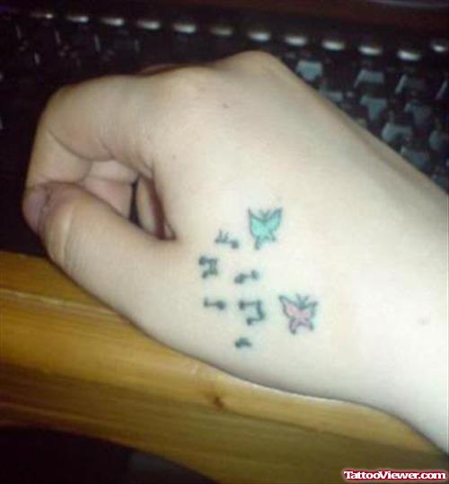Colored Butterflies And Music Notes Hand Tattoo