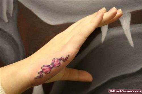 Pink Bow Side Hand Tattoo