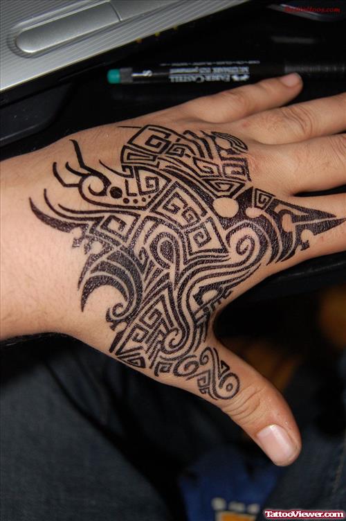Attractive Black Ink Tribal Tattoo On Left Hand