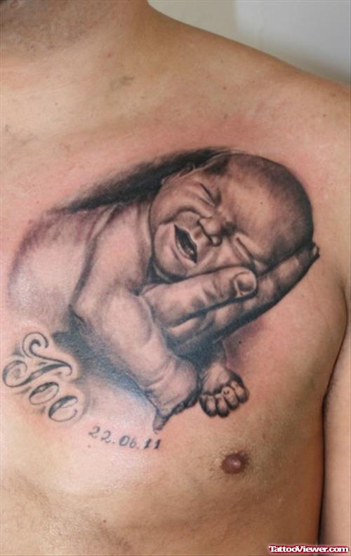 Grey Ink Baby In Hand Tattoo On Man Chest