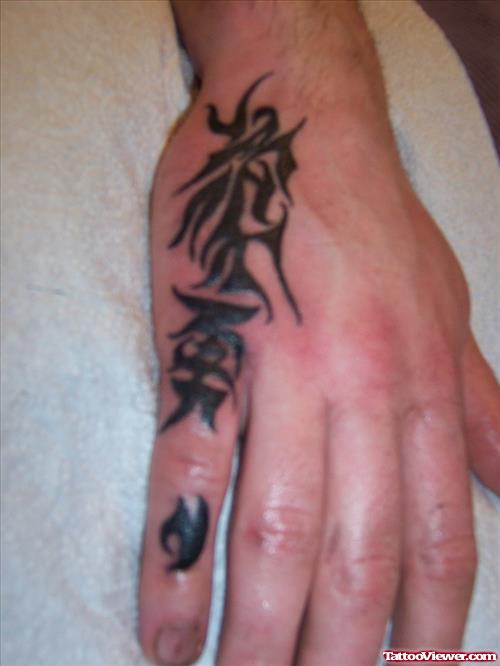 Amazing Black Ink Tribal Hand Tattoo For Men