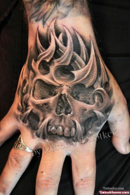 Amazing Grey Ink Tribal Skull Hand Tattoo