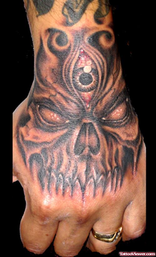 Grey Ink Horror Skull Hand Tattoo