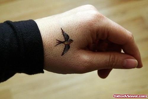 Black Ink Flying Bird Hand Tattoo