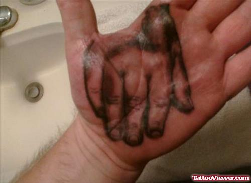 Grey Ink Baby Hand Tattoo On Palm