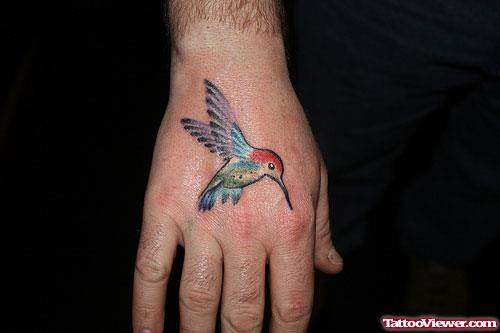 Colored Flying Hummingbird Tattoo On Right Hand
