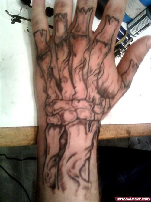 Amazing Grey Ink Skeleton Hand Tattoo