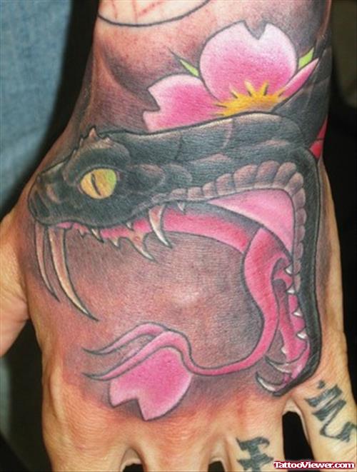 Pink Flower And Snake Head Hand Tattoo