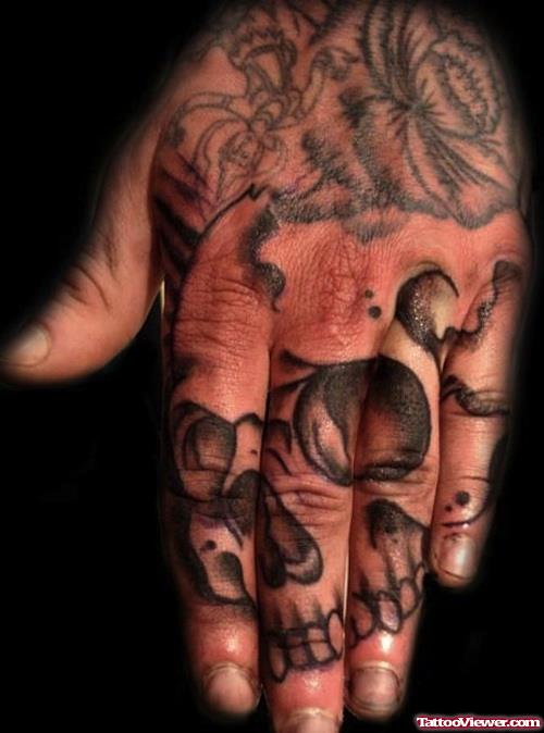 Attractive Grey Ink Skull Left Hand Tattoo