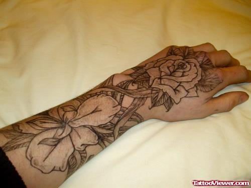 Nice Grey Ink Flowers Tattoos On Girl Left Hand