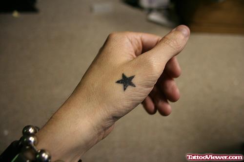 Small Black Star Hand Tattoo