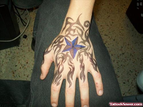 Tribal And Nautical Star Tattoo On Left Hand