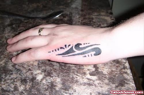 Amazing Black Ink Tribal Tattoo On Left Hand
