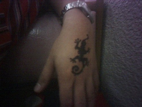 Black Tribal Geicko Tattoo On Left Hand