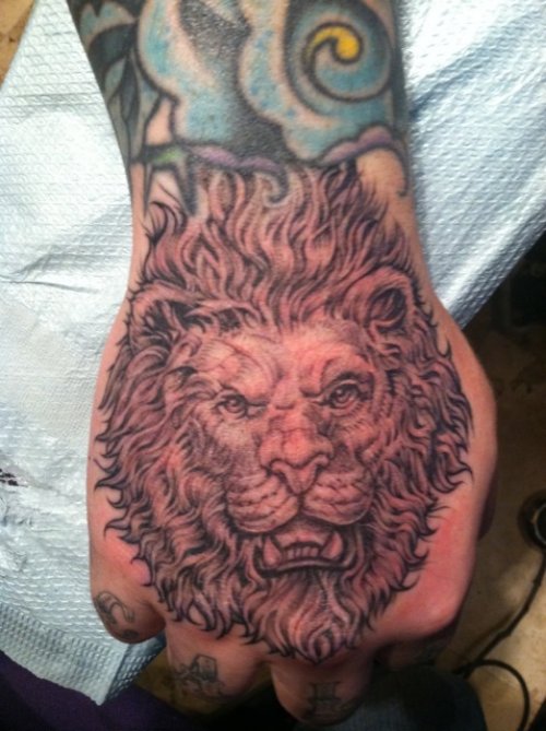 Grey Ink Lion Head Tattoo On Hand