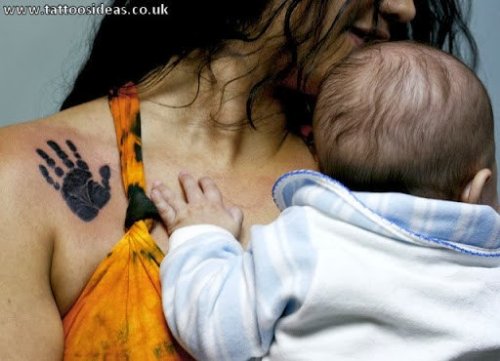 Black Ink Baby Hand Print Tattoo On Right Collarbone