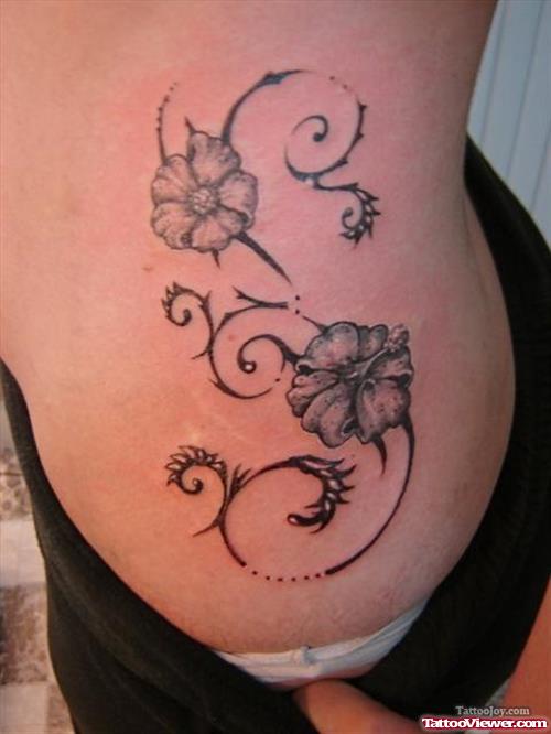 Grey Ink Hawaiian Flowers Tattoo On Side Rib