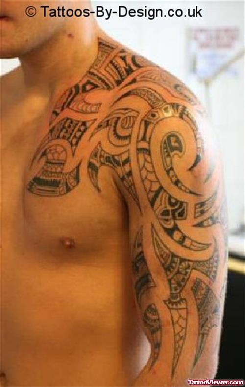 Grey Ink Tribal Hawaiian Tattoo On Man Chest And Half Sleeve