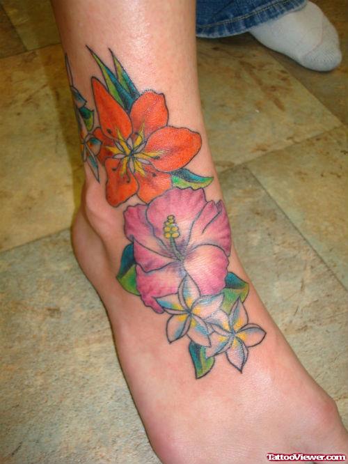 Awesome Colored Hawaiian Flowers Tattoos On Right foot