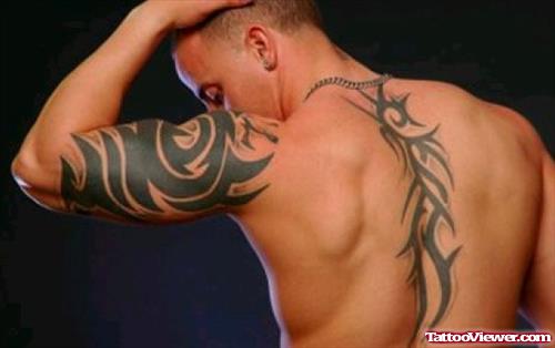 Tribal Hawaiian Tattoo On Back And Left Half Sleeve