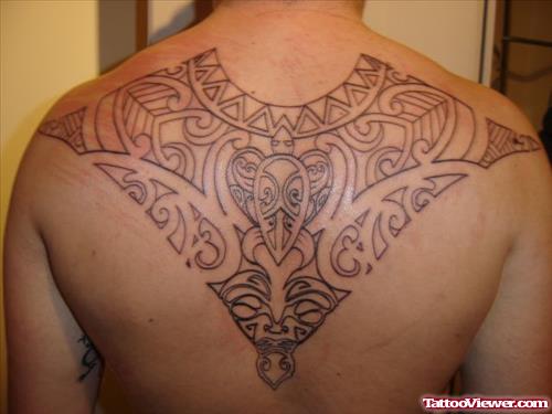 Grey Ink Hawaiian Tattoo On Man Upperback