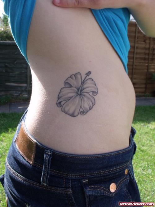 Grey Ink Hawaiian Flower Tattoo On Side