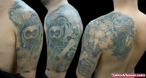 Grey Ink Hawaiian Tattoo On Man Left Shoulder