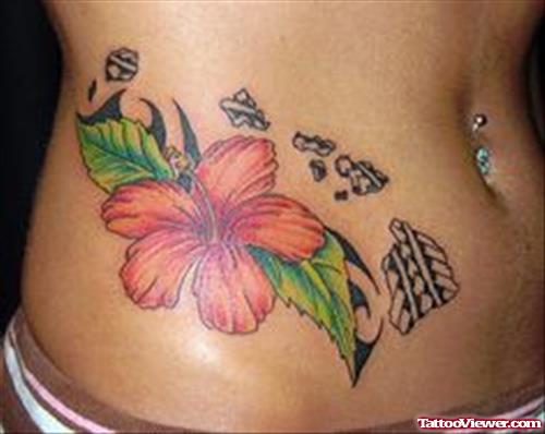 Hawaiian Flower And Tribal Tattoo On Right Hip