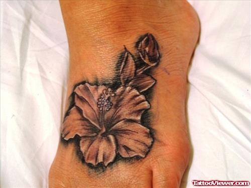 Grey Ink Hawaiian Flower Tattoo On Left Foot