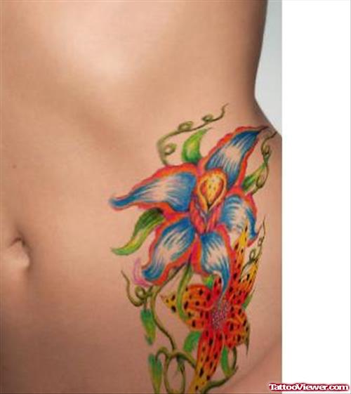 Colored Hawaiian Tattoo On Left Hip
