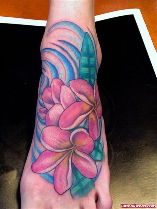 Colored Hawaiian Flowers Tattoos On Left Foot